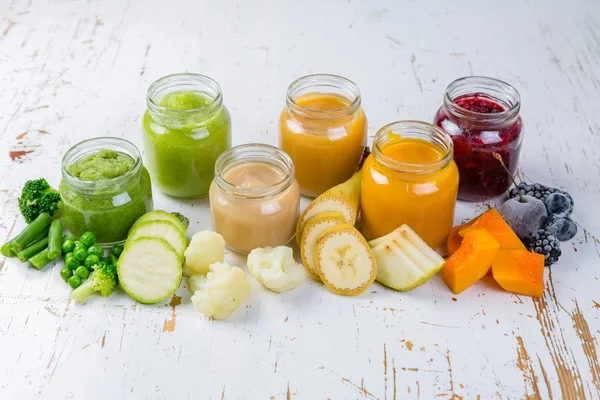 Colorful baby food purees in glass jars — Stock Photo, Image
