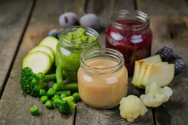 Colorful baby food purees in glass jars — Stock Photo, Image