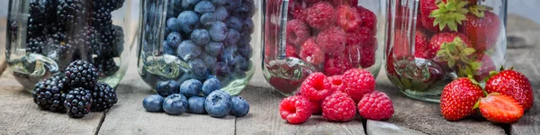 Berries in glass jars - homemade jam, smoothie, low fat dessert