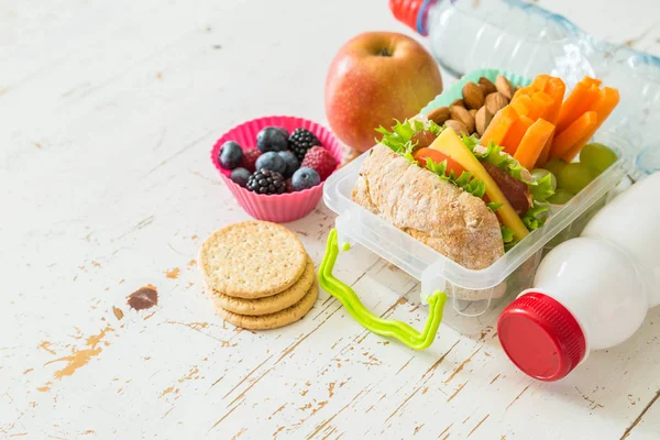 School lunch box with books and pencils in front of black board — Stock Photo, Image