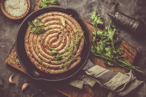 Barbeque sausages on cast iron pan — Stock Photo, Image