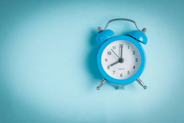 Morning concept - vintage clock on blue background — Stock Photo, Image