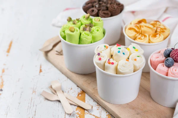 Selection of different rolled ice creams in cone cups — Stock Photo, Image