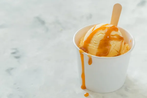 Caramel ice cream in paper cone