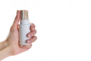 Pahalı ilaçlar kavramı - euro faturaları ile uyuşturucu kapsayıcı tutan el