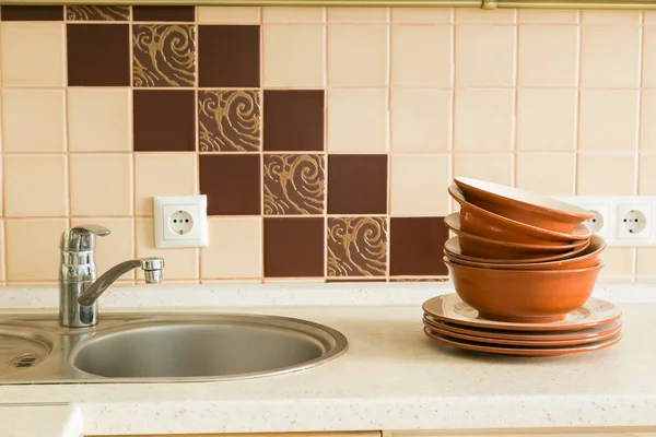 Посуда в раковине с кухонным фоном — стоковое фото