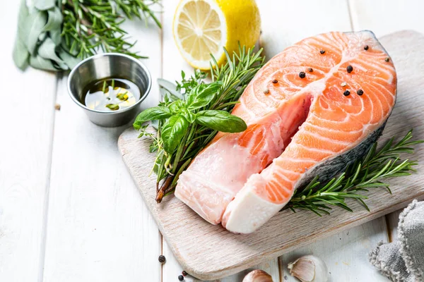 Raw salmon with herbs and spices, rustic background — Stock Photo, Image