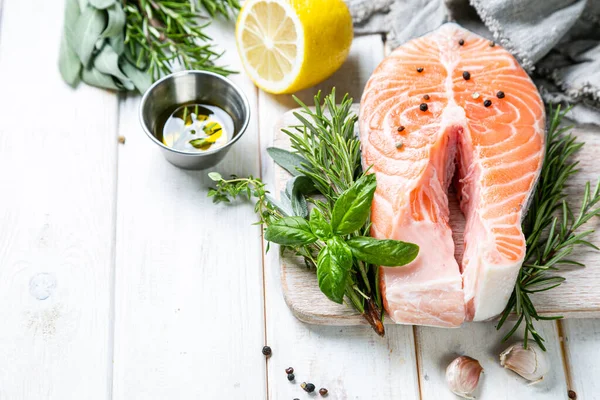 Raw salmon with herbs and spices, rustic background — ストック写真