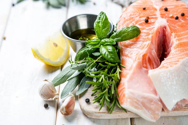 Raw salmon with herbs and spices, rustic background — Stock Photo, Image