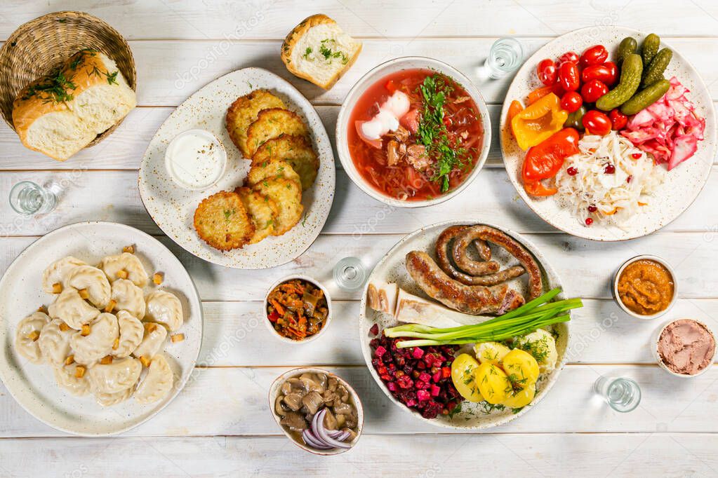Selection of traditional ukrainian food - borsch, perogies, potato cakes, pickled vegetables