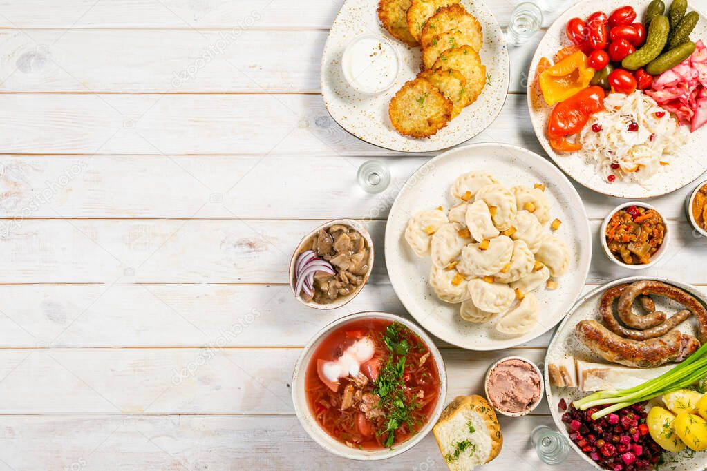 Selection of traditional ukrainian food - borsch, perogies, potato cakes, pickled vegetables