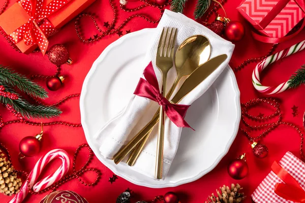 Christmas tableware and decorations on red background — Stock Photo, Image