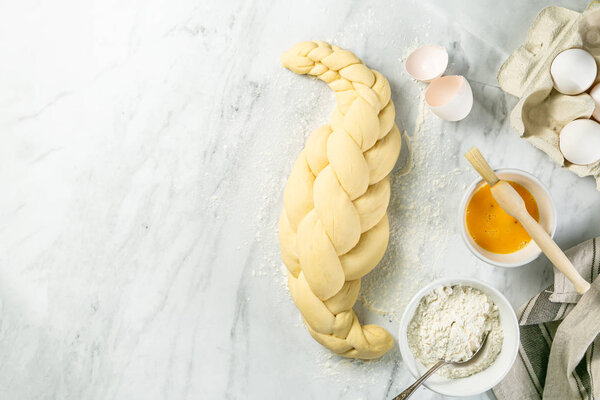 Making traditional jewish challah bread on marble background