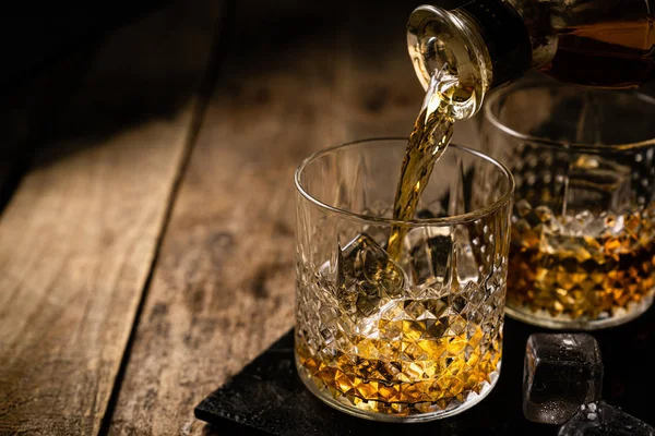 Whiskey in glasses on wood background — 스톡 사진