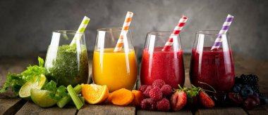 Selection of colorful smoothies in glasses clipart