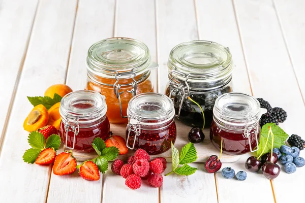 Selection of berry jams in glass jars — 스톡 사진