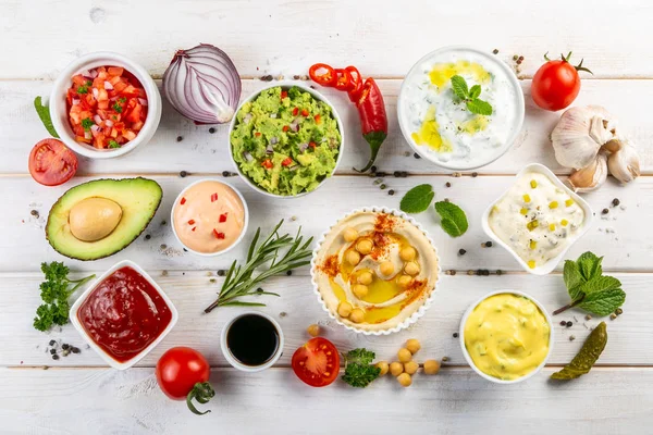 Selection of sauces in white bowls on white bowls — Stock Photo, Image