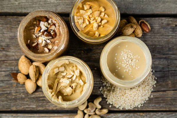 Urval av nötter smör - jordnöt, cashew, mandel och sesam frön — Stockfoto