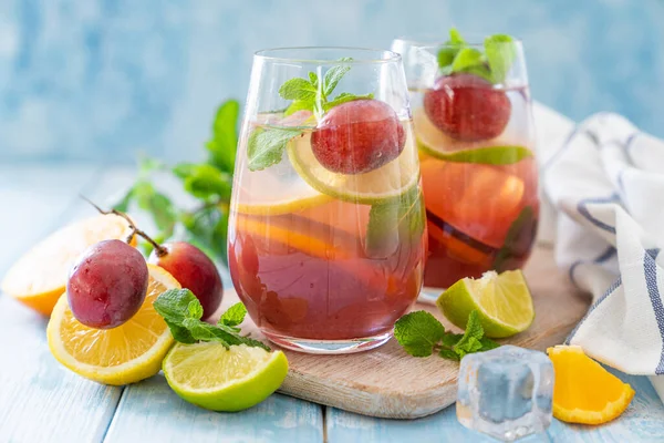 Sangria and ingredients on blue wood background — 스톡 사진