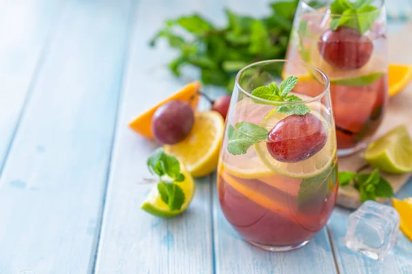 Sangria and ingredients on blue wood background — 스톡 사진