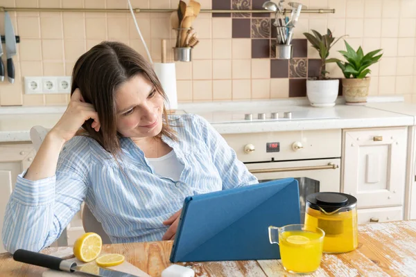 Female enjoys staying at home - watching movie, drinking tea