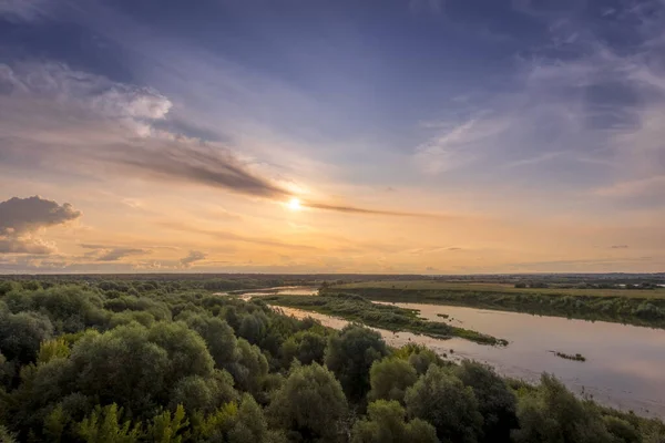 stock image Aerial view to sunset on the river at summer evening with cloudy sky.
