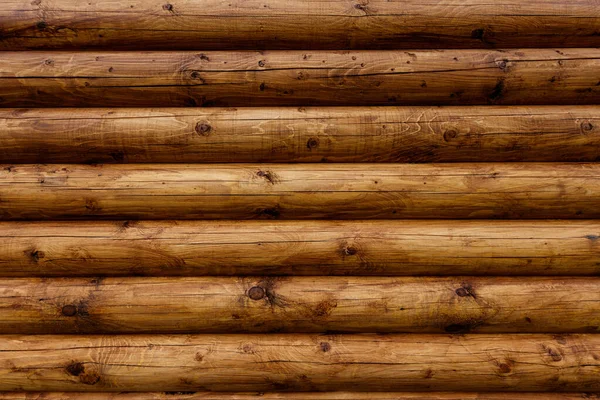 Wooden wall from logs as a background. Stock Photo