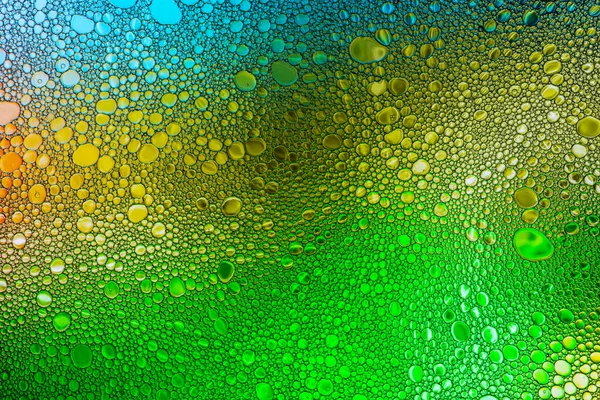Kolorowe krople oleju na wodę. — Zdjęcie stockowe
