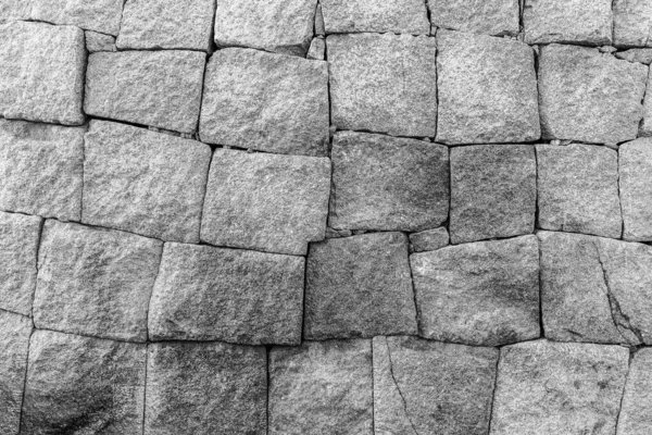 Monochrome background of old stone brick wall. Royalty Free Stock Photos