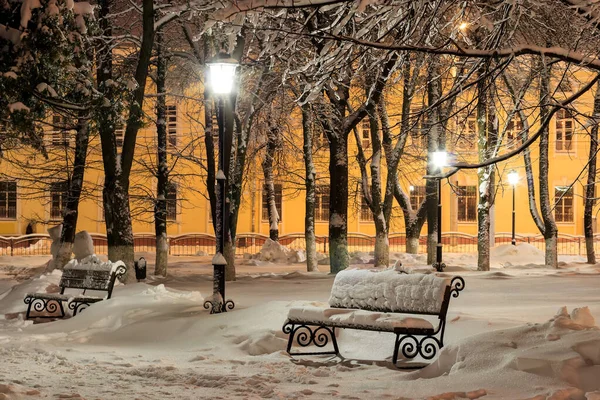 Скамейка в зимнем парке ночью . — стоковое фото