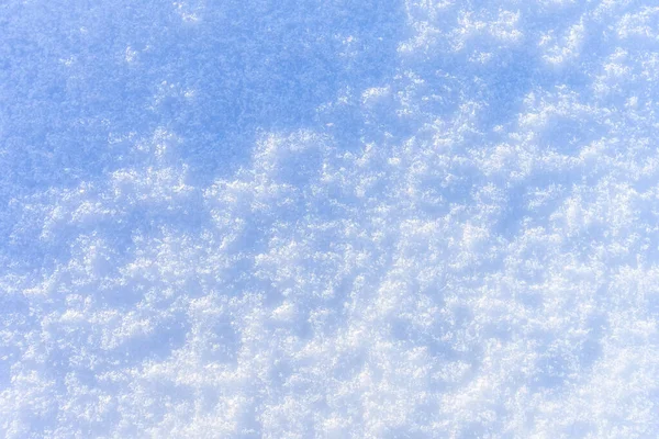 Textura de nieve en el soleado día de invierno. Fondo abstracto . —  Fotos de Stock