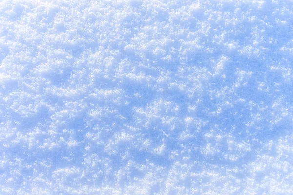 Sněhová textura za slunečného zimního dne. Abstraktní pozadí. — Stock fotografie