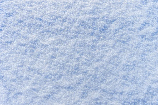 Schnee Textur an einem sonnigen Wintertag. Abstrakter Hintergrund. — Stockfoto