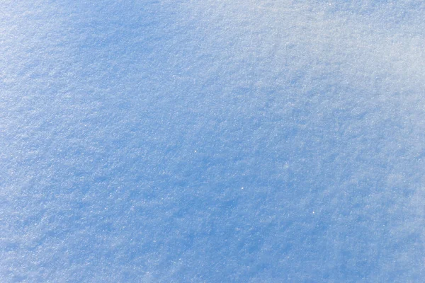 Schnee Textur an einem sonnigen Wintertag. Abstrakter Hintergrund. — Stockfoto