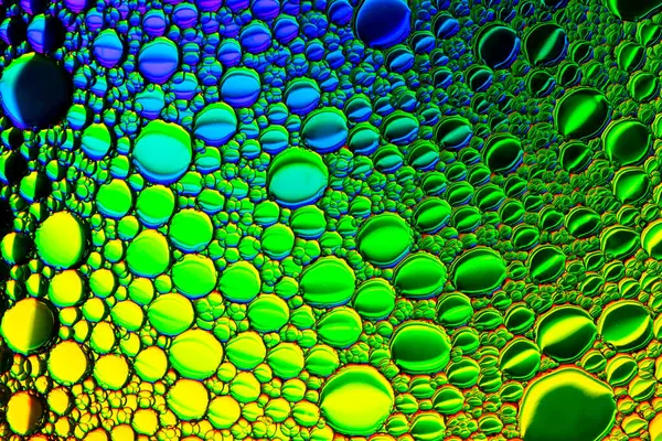 Top view on colorful drops of oil on the water. Circles and oval — Stock Photo, Image