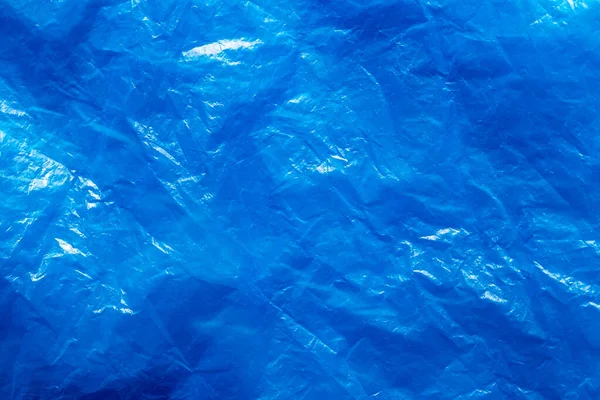 Textura de saco de lixo de plástico azul amassado. Contexto abstrato — Fotografia de Stock