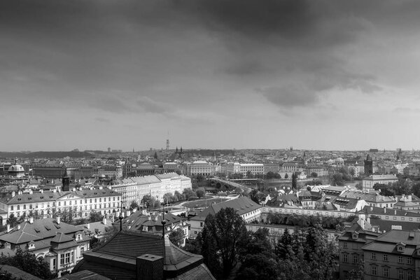 Prague cityscape panorama with red roofs roof. Street top view in a cloudy day. The capital of the Czech Republic. Black and white photo. Monochrome.