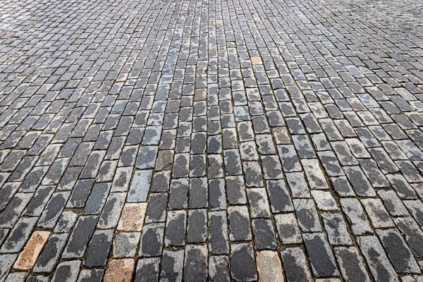 Top view on paving wet stone road after rain. Old pavement of gr — Stock Photo, Image