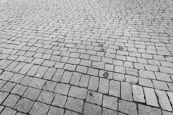 Вид сверху на асфальтированную каменную дорогу. Старый тротуар из гранитной текстуры . — стоковое фото