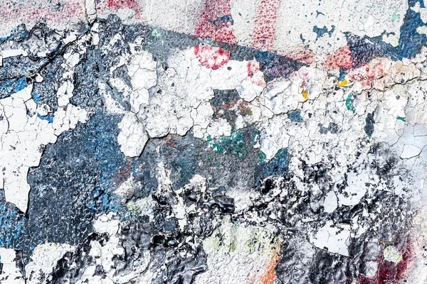 Fragment of colored graffiti painted on a wall. Bright abstract background for design with peeling paint.