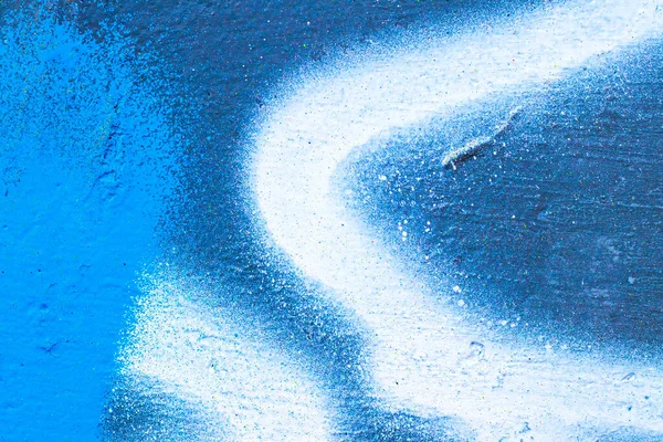 Fragment of colorful graffiti painted on a concrete wall. Bright  blue abstract background for design.