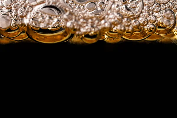 Texture of foam and gas bubbles in light beer. Abstract background for design.