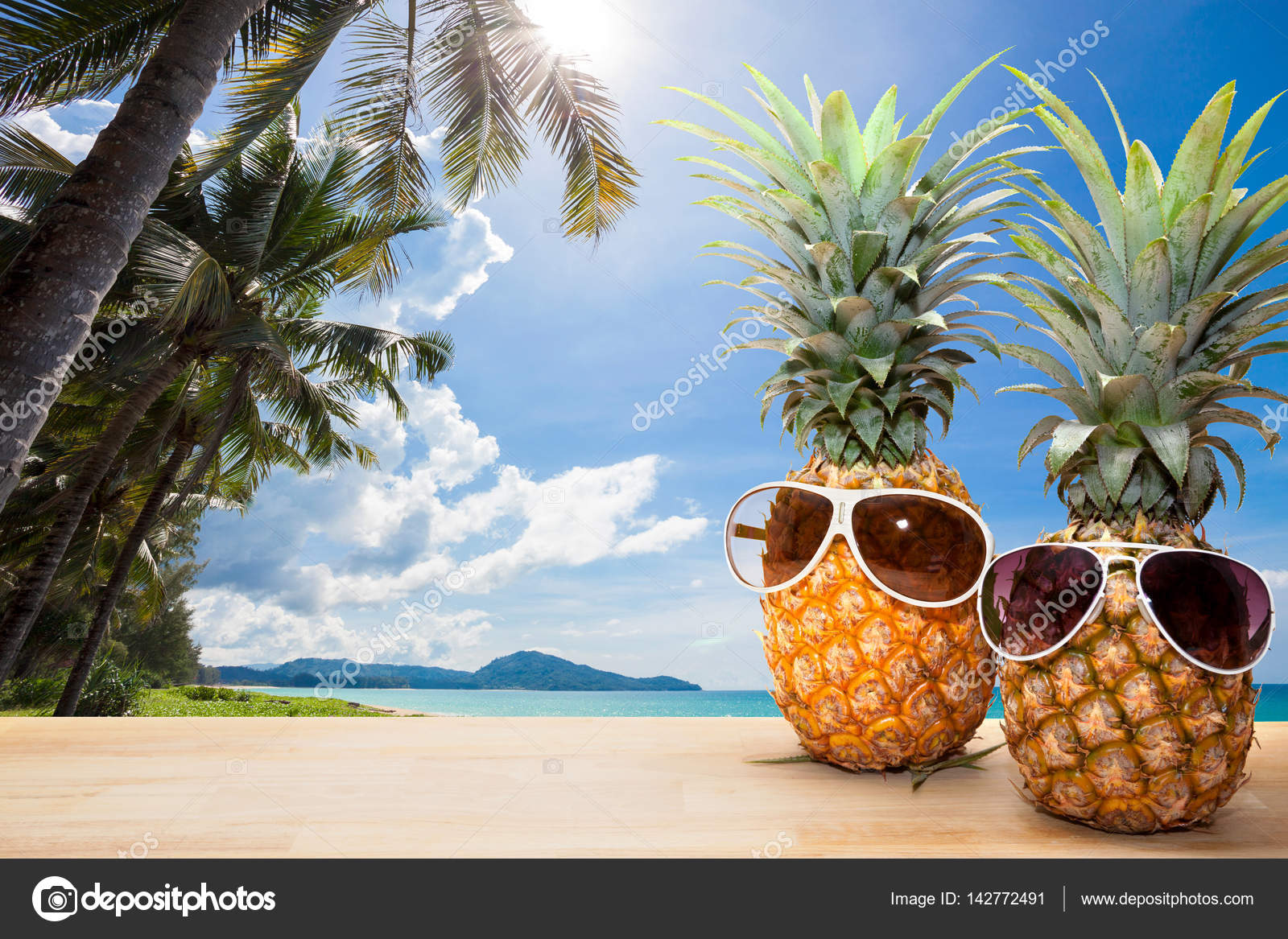 Pineapple with sunglasses on wood,concept summer background. Stock
