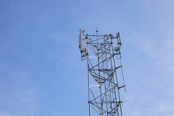 Antenna phone tower on blue sky background. Stock Picture