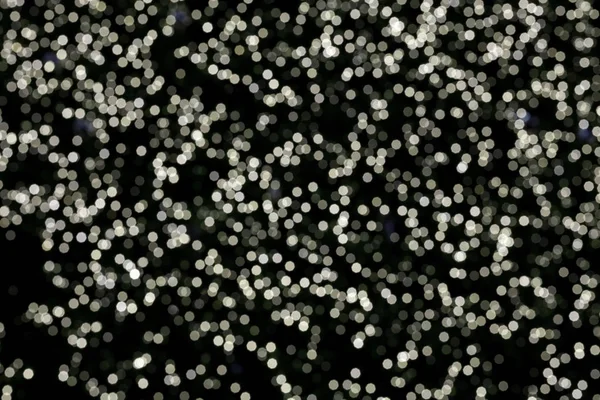 Abstrato bokeh natal luzes textura no fundo preto. — Fotografia de Stock