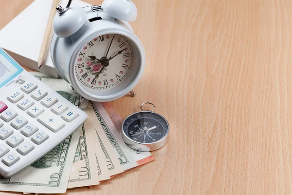 Dollars banknote with white alarm clock,compass,calculator — Stock Photo, Image