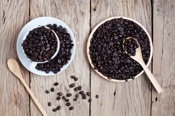 Szemes kávé kávé csésze régi fából készült deszka háttér. — Stock Fotó