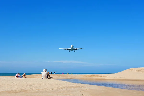 Airplane landing above Beautiful tropical sea