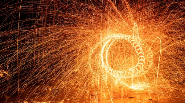 Swing fire Swirl steel wool light photography over the stone