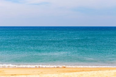 Tropical sandy beach with blue ocean and blue sky background ima